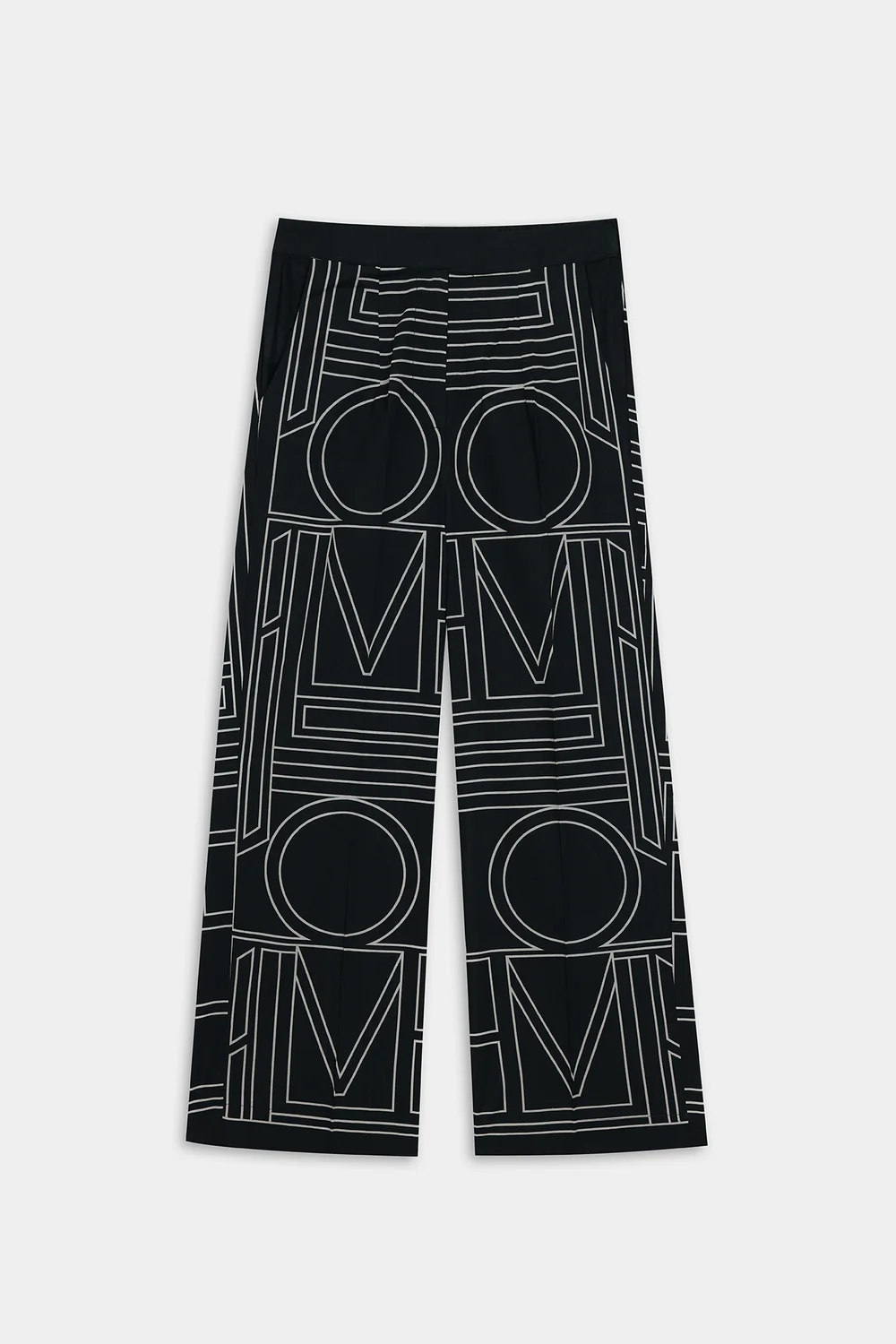 Lifestyle view showcasing the contemporary ban neckline top and elongating straight-fit trousers of the monochromatic geometric matching set.