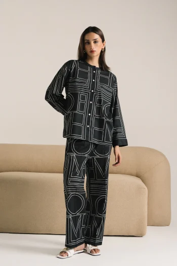 Front studio portrait of Biljiki jet black geometric patterned two-piece set on a 5'6 model.