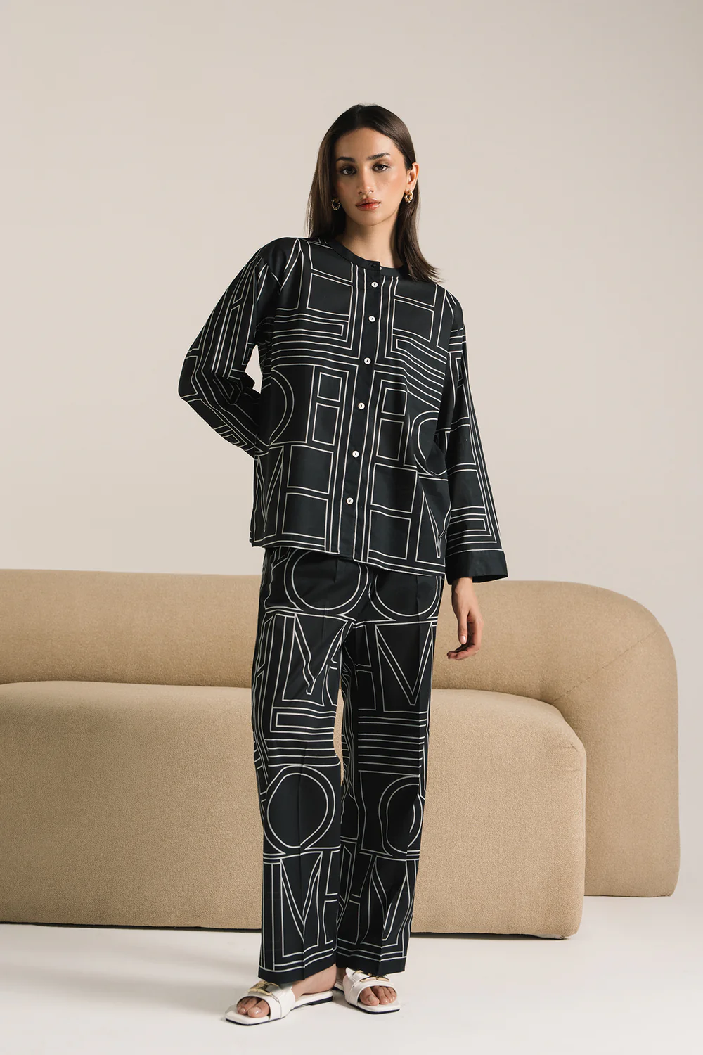 Front studio portrait of Biljiki jet black geometric patterned two-piece set on a 5'6 model.