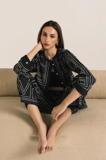Front studio portrait of Biljiki jet black geometric patterned two-piece set on a 5'6 model.