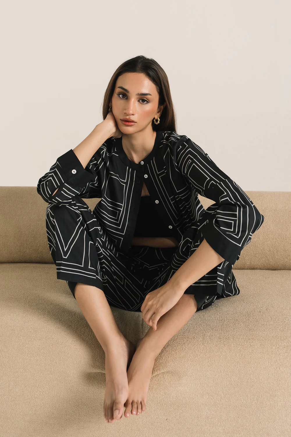 Front studio portrait of Biljiki jet black geometric patterned two-piece set on a 5'6 model.