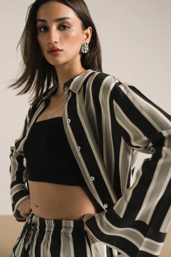 Front studio portrait of Biljiki black striped two-piece set on a 5'6 model.