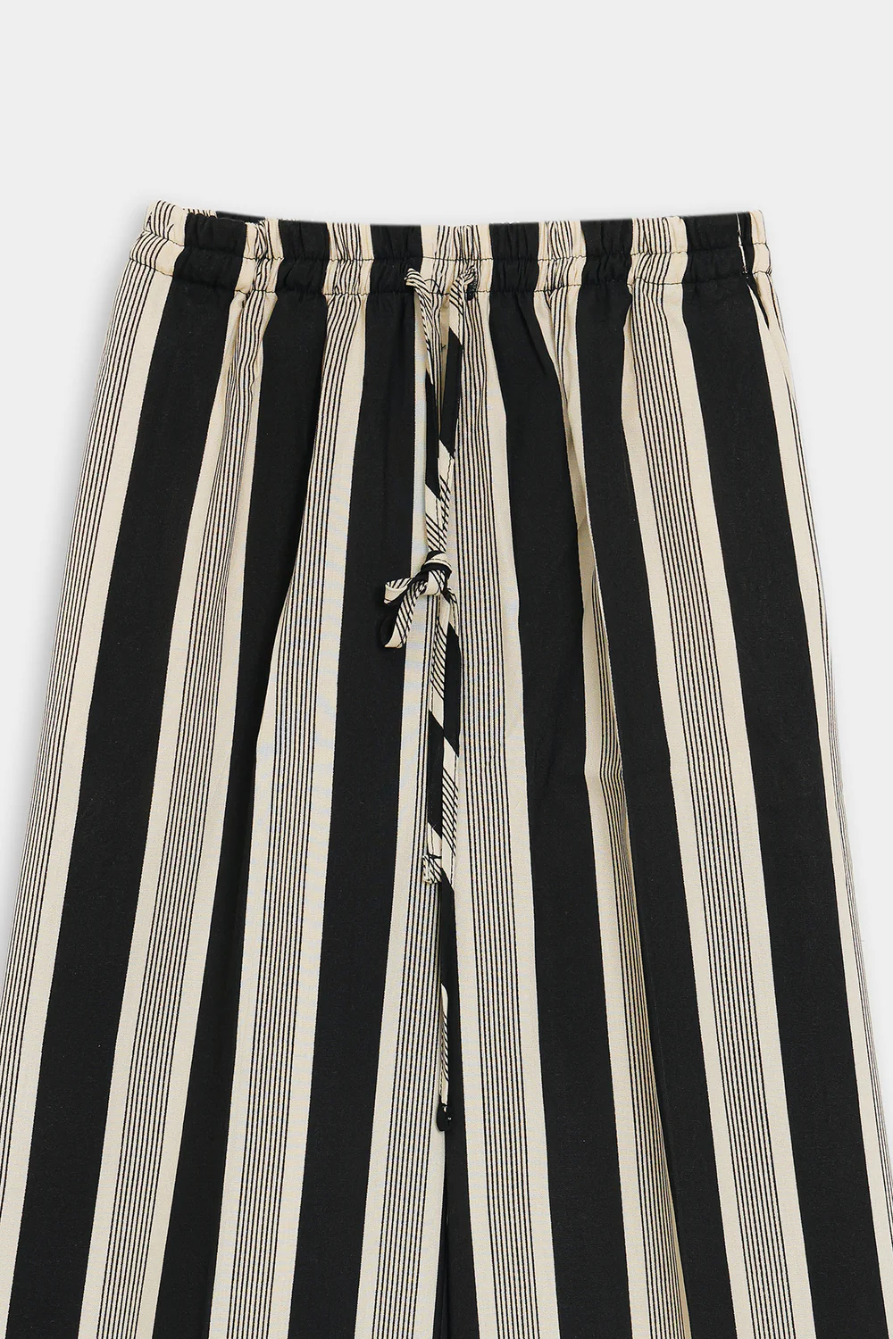 Close-up shot highlighting the sharp linear stripe print and fluid drape of the premium black viscose fabric.