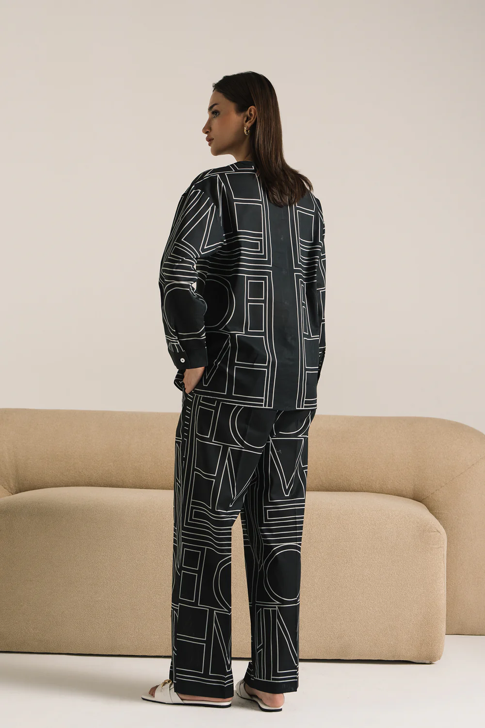 Close-up shot highlighting the sharp white geometric pattern, ban neckline, and textured viscose-linen blend of the premium black tunic.