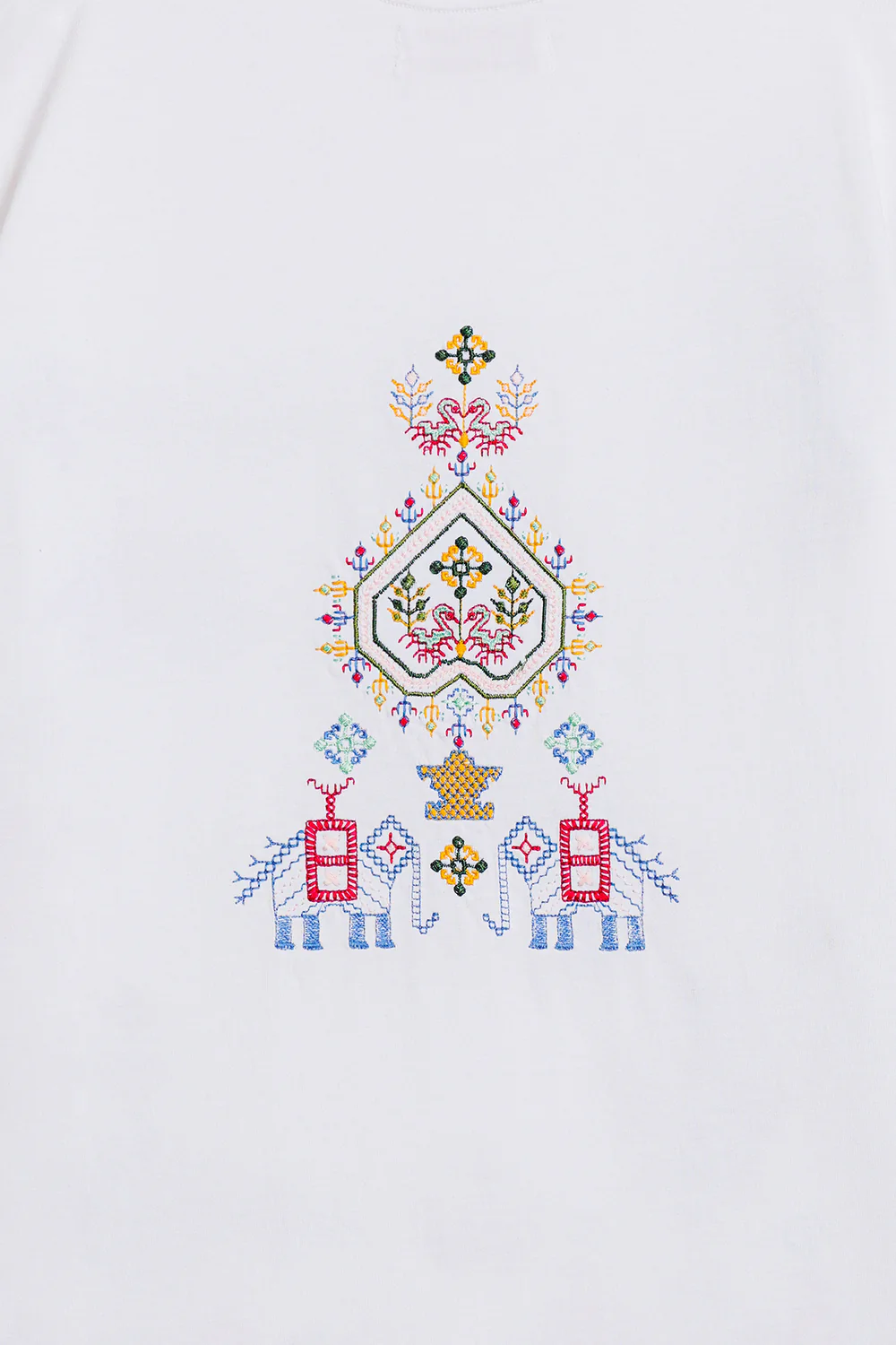 Close-up shot highlighting the intricate, multi-colored geometric and abstract threadwork on the premium crisp white textile.