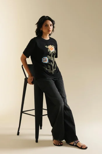Lifestyle view showcasing the relaxed fit and contemporary drape of the digital-inspired black embroidered t-shirt.