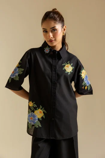 Close-up shot highlighting the vibrant multi-colored floral cross-stitch embroidery on the premium jet black canvas.
