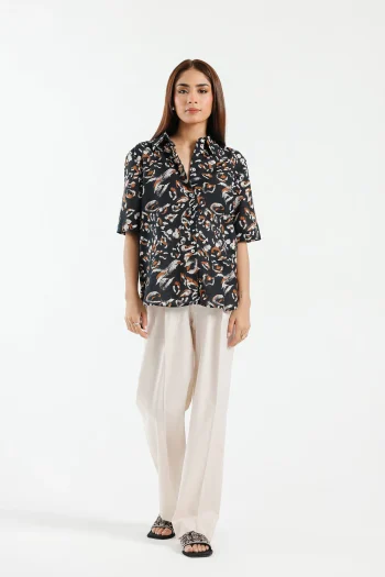 Front studio portrait of Biljiki jet black artistic printed cotton-linen button-down shirt on a 5'6 model.