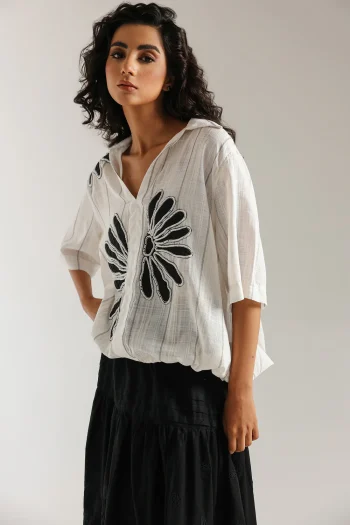 Front studio portrait of Biljiki jet black tiered blouse featuring a vibrant polychrome collage print on a 5'6 model.