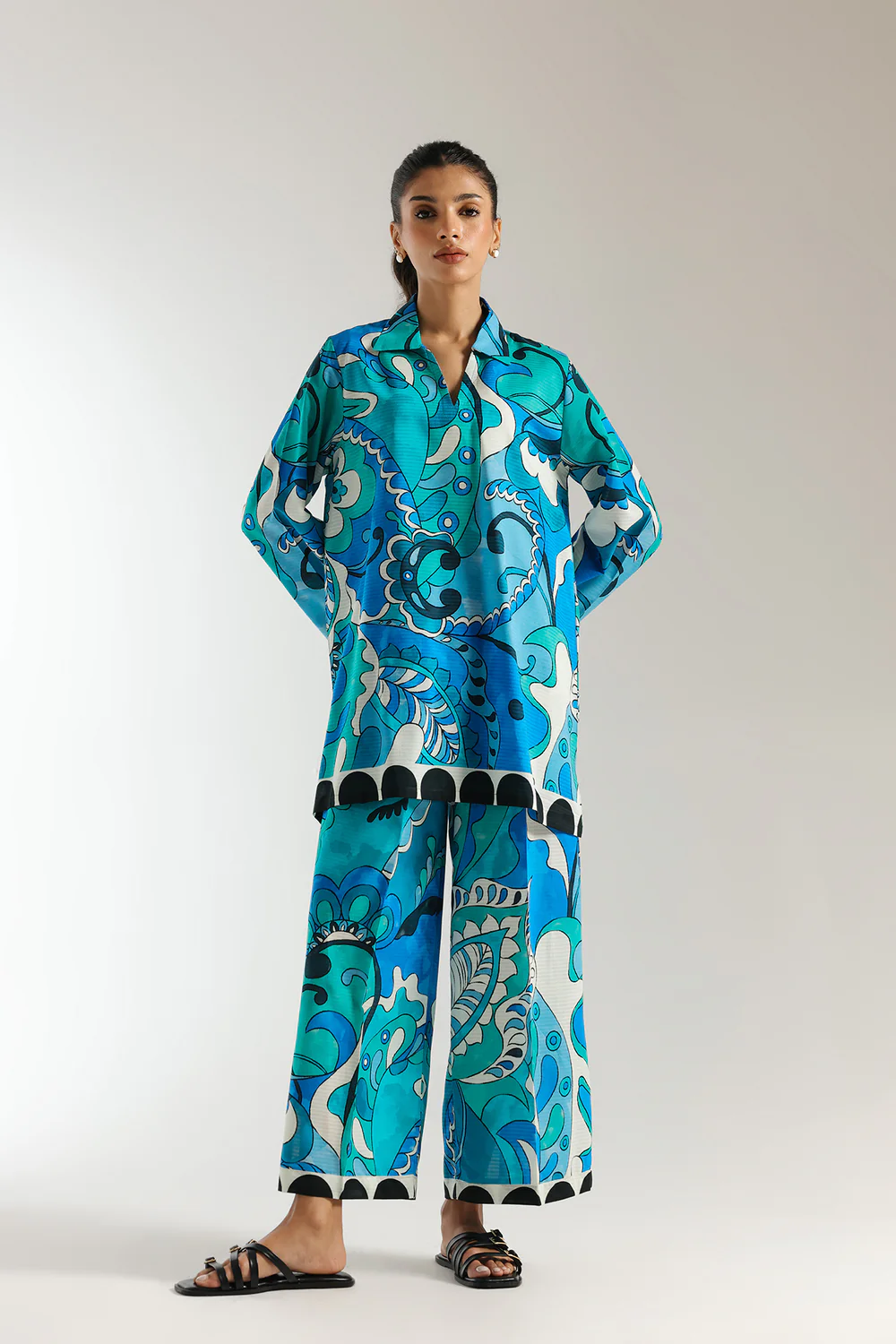 Front studio portrait of Biljiki vibrant blue-green artistic printed two-piece culotte set on a 5'6 model.