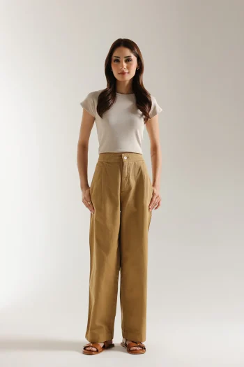 Front studio portrait of Biljiki rich chestnut brown straight-fit pleated trousers on a 5'6 model.