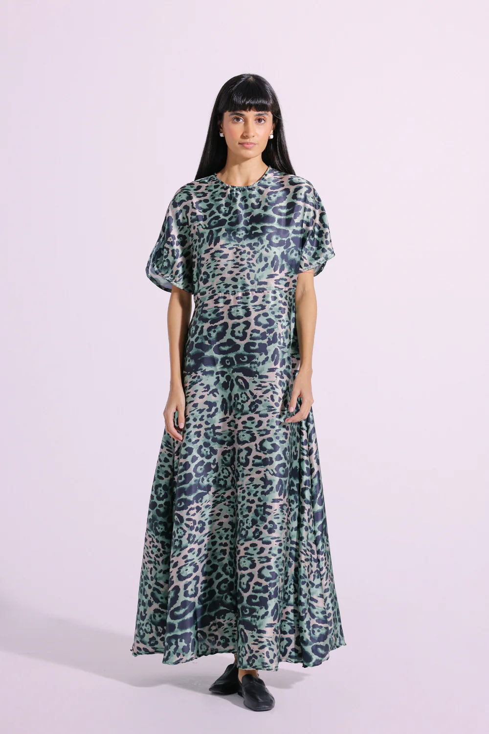 Front studio portrait of Biljiki verdant green animal printed elongated maxi dress on a 5'6 model.