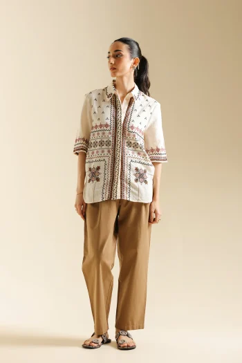 Front studio portrait of Biljiki light khaki relaxed-fit pleated trousers on a 5'6 model.