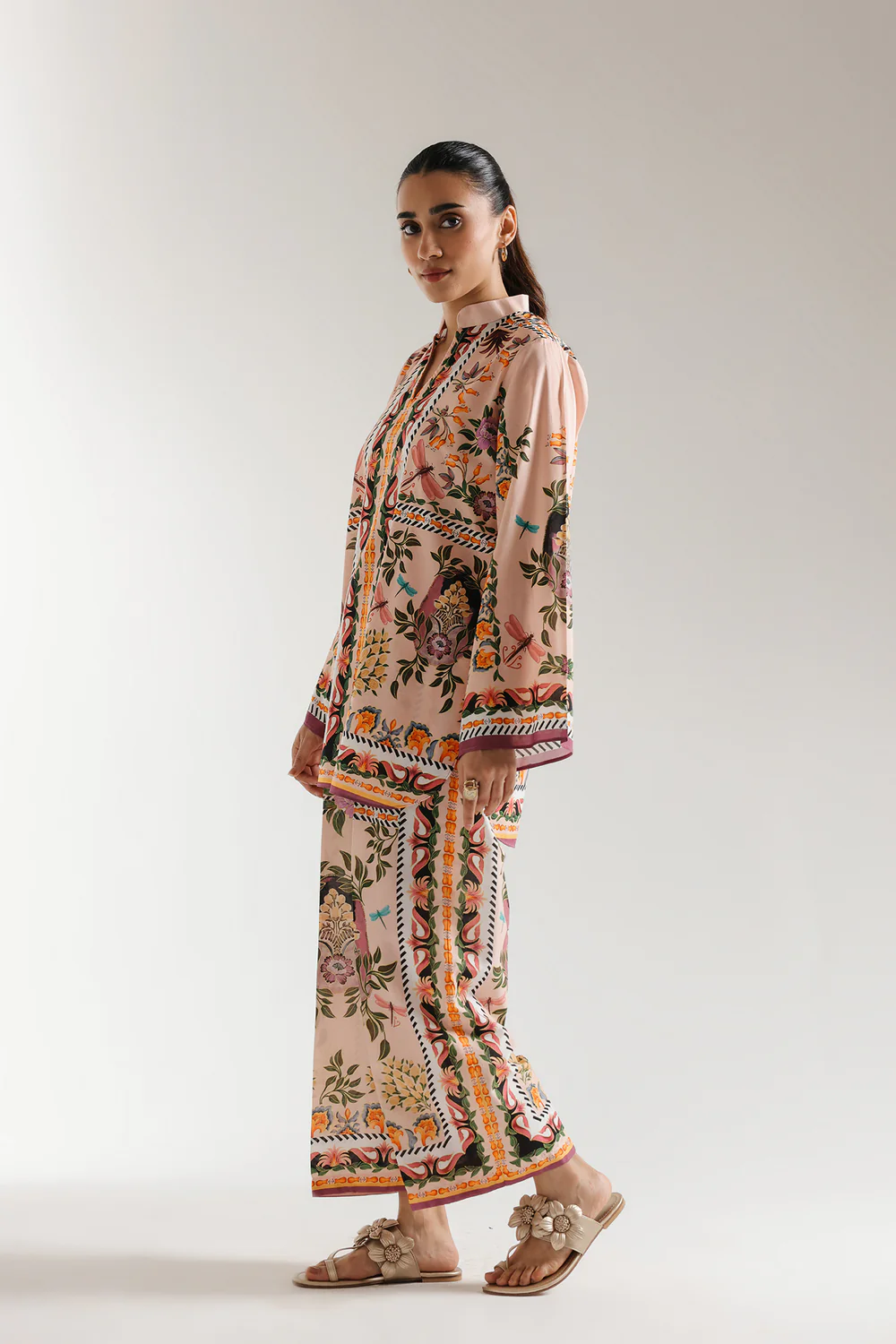 Lifestyle view showcasing the architectural square hem of the short shirt and the straight culotte trousers of the contemporary matching set.