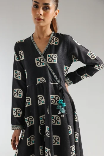 Close-up shot highlighting the intricate neckline embroidery, artisanal dori tassels, and vibrant turquoise print on the textured black karandi fabric.