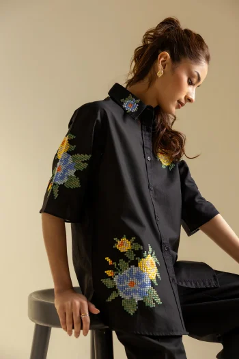 Lifestyle view showcasing the contemporary silhouette and structural drape of the artisanal embroidered black shirt.