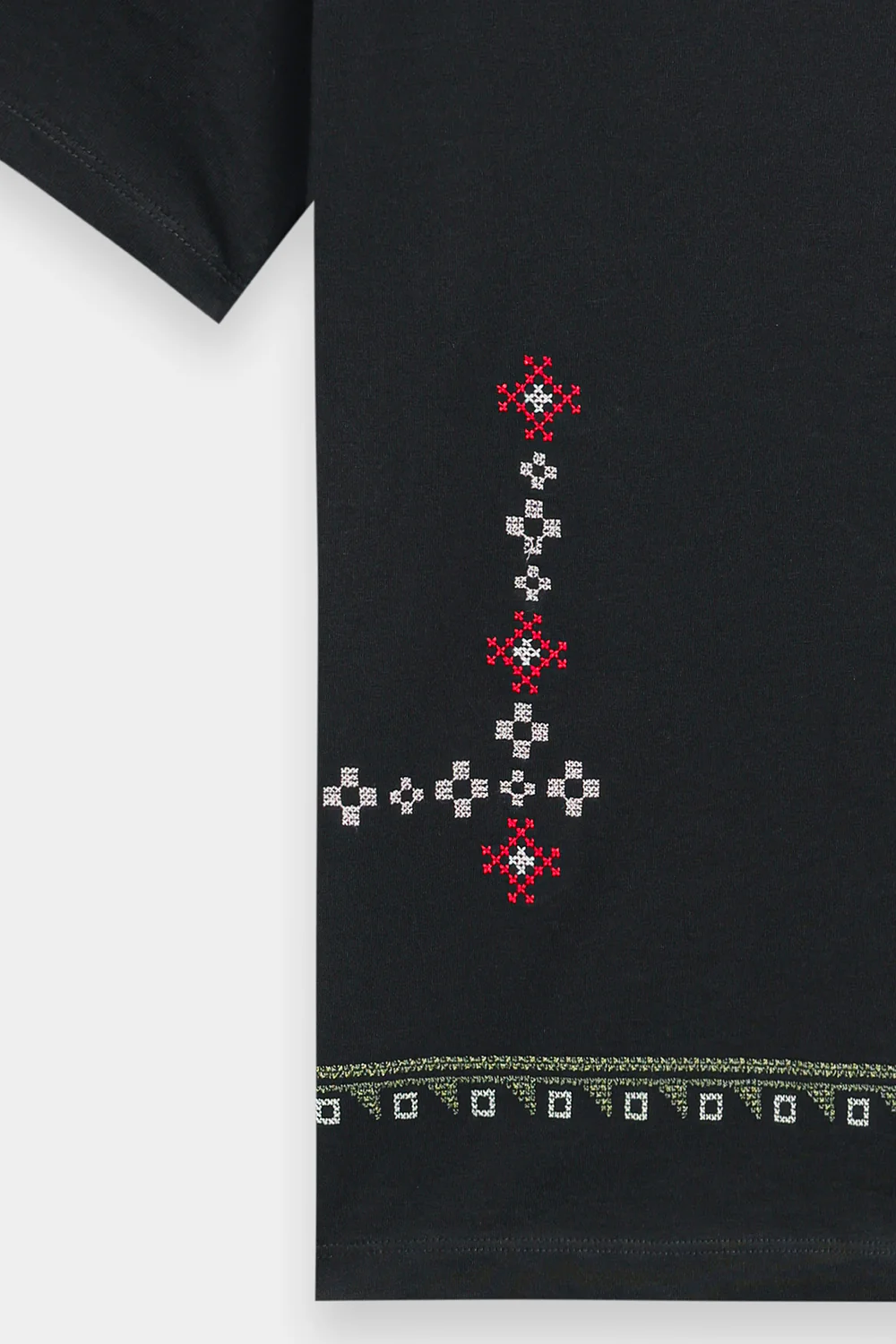 Close-up shot highlighting the intricate, multi-colored geometric and abstract threadwork on the premium deep black textile.