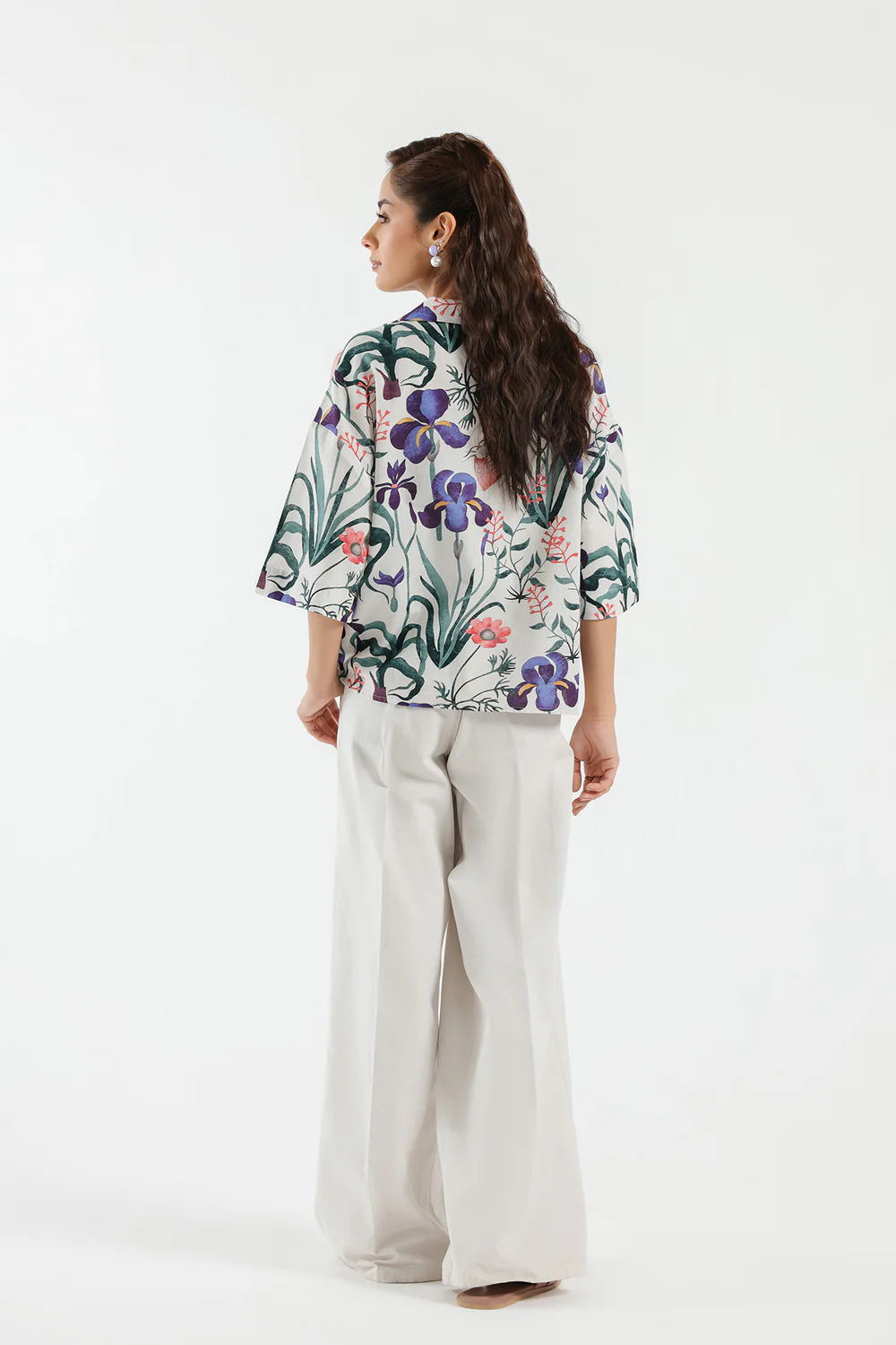 Lifestyle view showcasing the contemporary cropped silhouette and tailored drape of the vibrant botanical linen shirt.