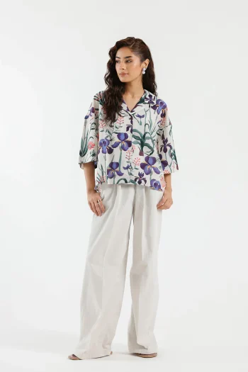 Front studio portrait of Biljiki white botanical floral cropped cotton-linen shirt on a 5'6 model.