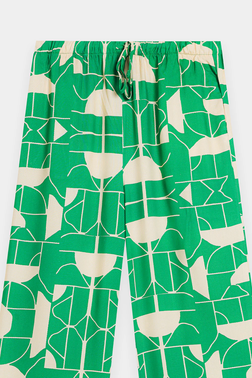 Close-up shot highlighting the bold contrasting optical illusion motif and silken drape of the premium green viscose fabric.