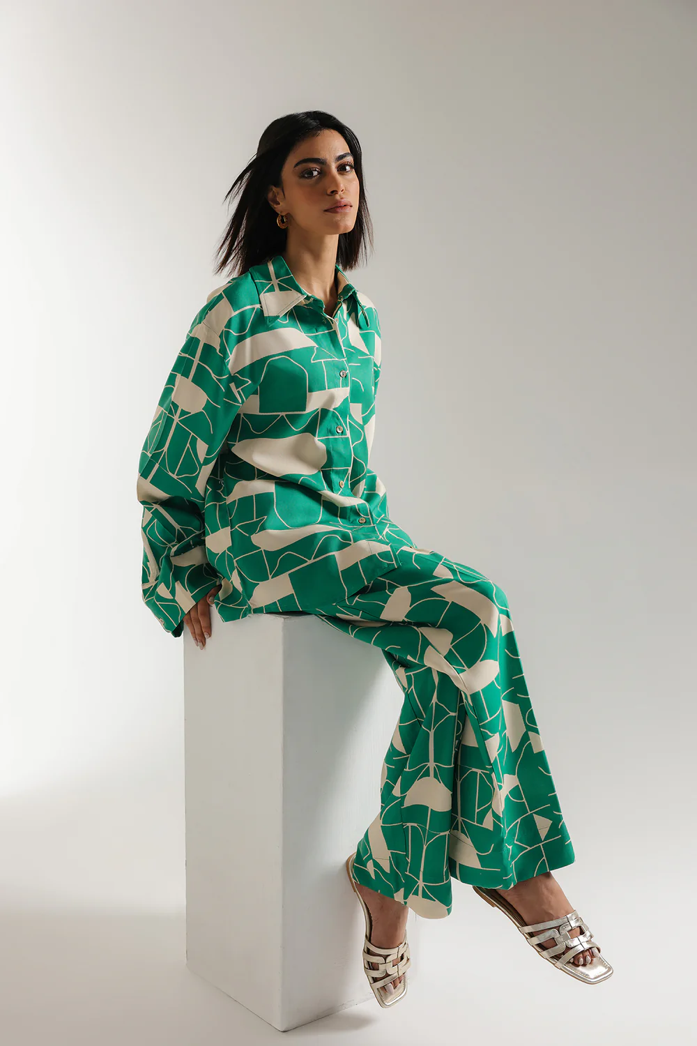 Front studio portrait of Biljiki verdant green optical illusion printed two-piece set on a 5'6 model.