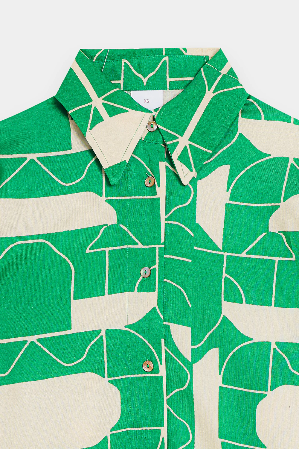Close-up shot highlighting the bold contrasting optical illusion motif and silken drape of the premium green viscose fabric.