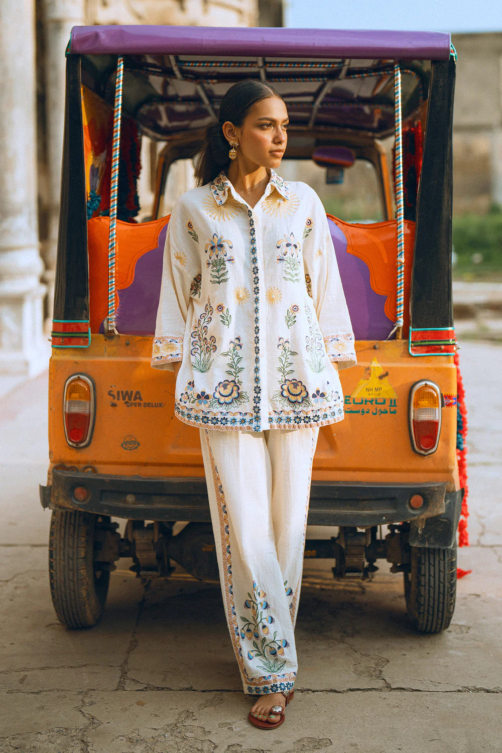 Close-up shot highlighting the intricate multi-colored botanical embroidery on the premium creamy vanilla ice canvas.