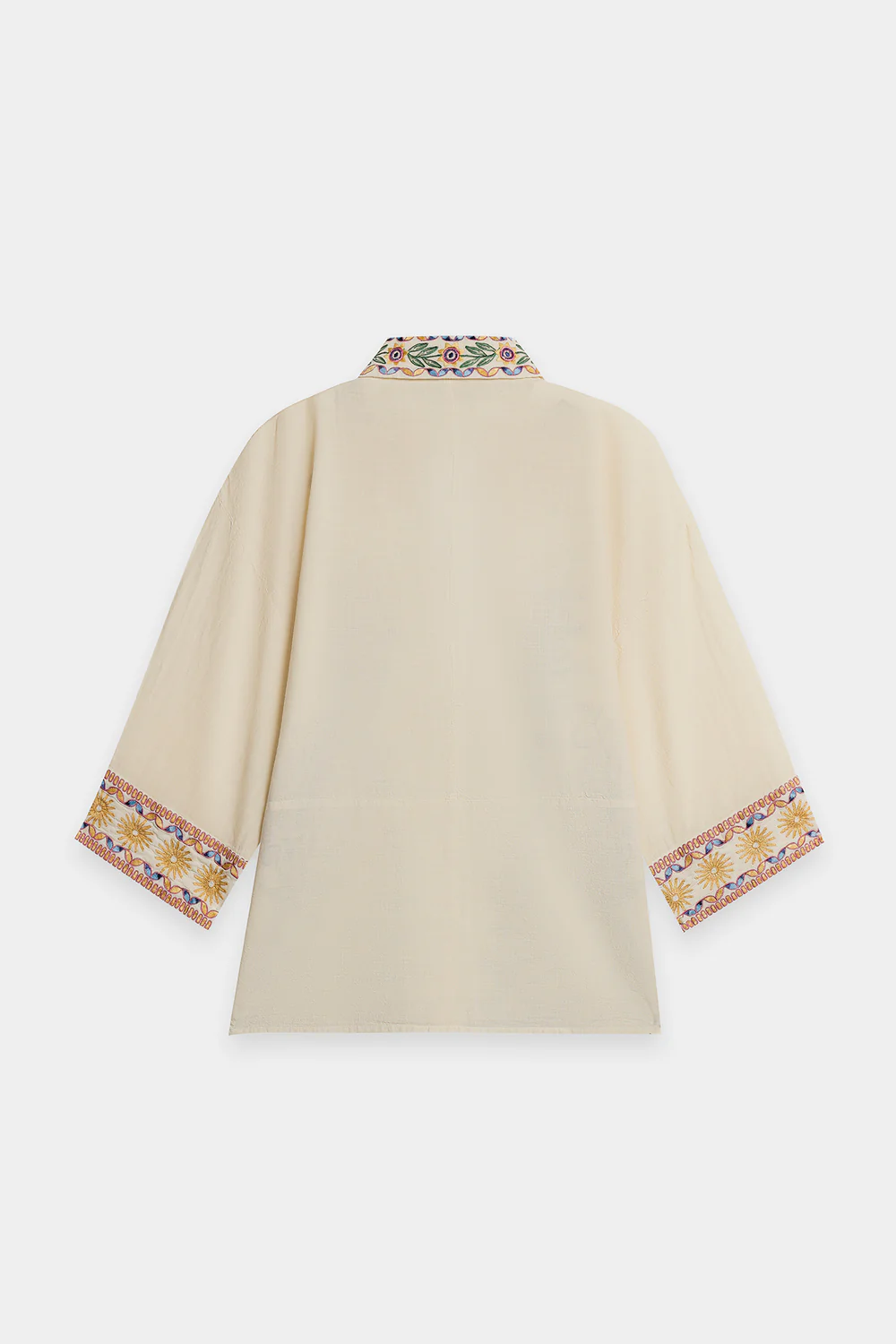 Lifestyle view showcasing the relaxed button-down silhouette and matching embroidered straight-fit trousers of the contemporary artisanal matching set.