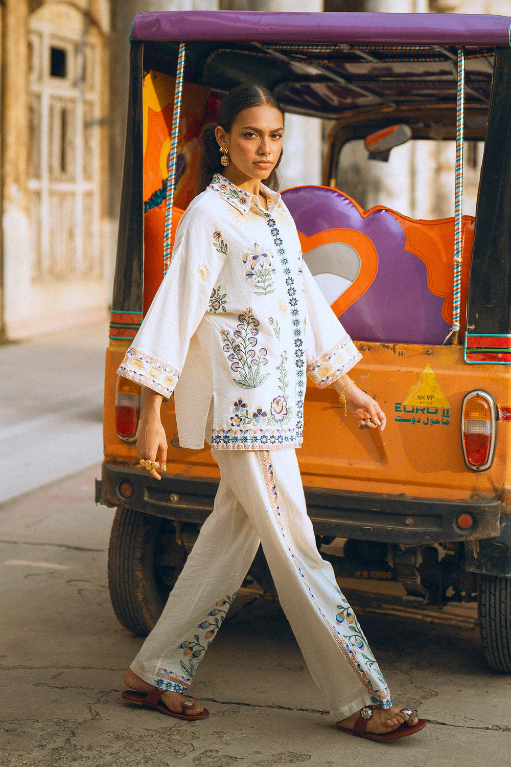 Close-up shot highlighting the intricate multi-colored botanical embroidery on the premium creamy vanilla ice canvas.