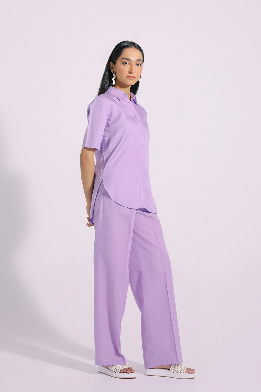 Side view showing relaxed fit and curved bottom of pastel shirt