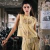Model wearing sleeveless yellow kurti with floral embroidery