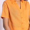 Close-up of peach shirt fabric and button details