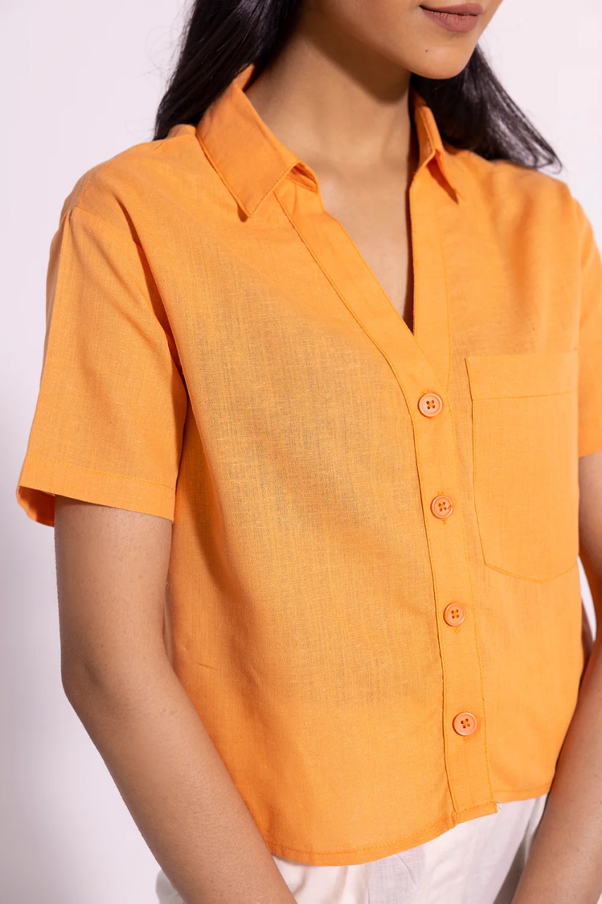 Close-up of peach shirt fabric and button details